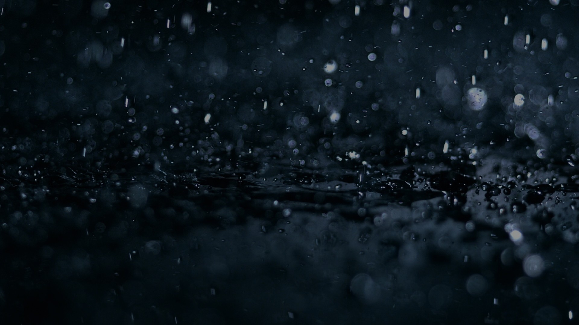 Heavy rain falling on a dark Rolls-Royce Motor Car