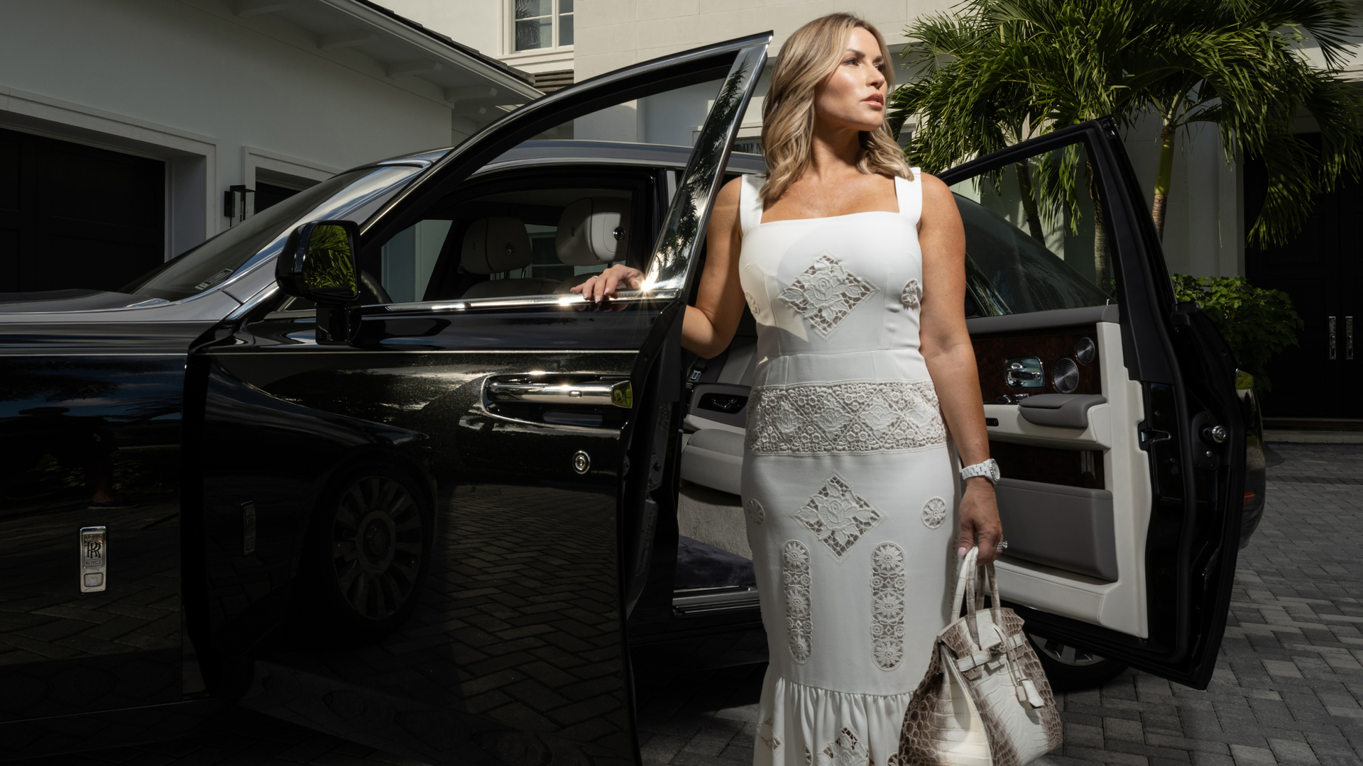 Kristin Brown next to her Rolls-Royce in front of her house