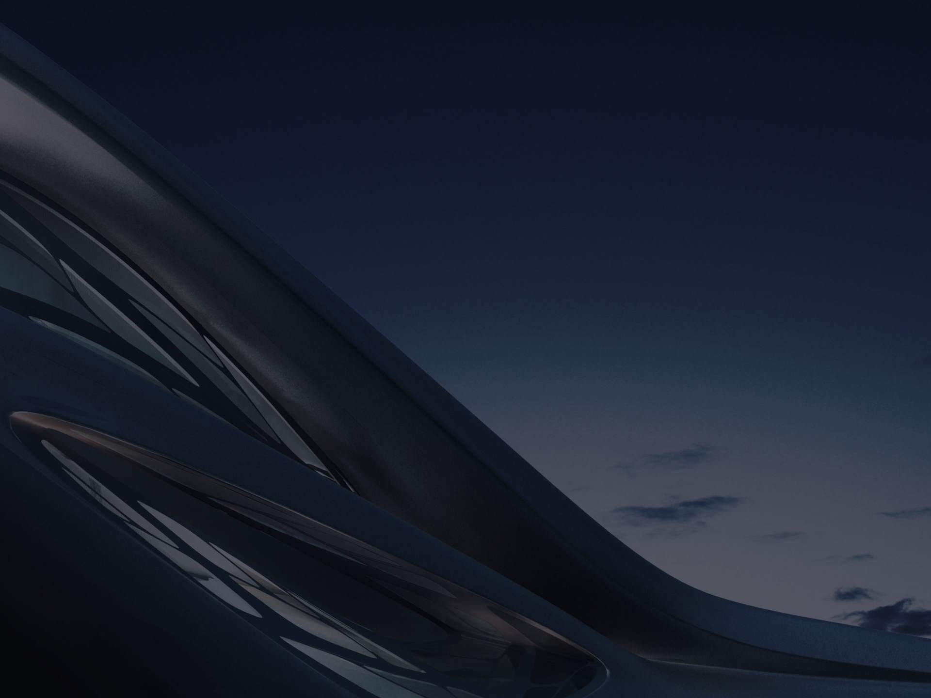 The exterior of a contemporary building at night. 