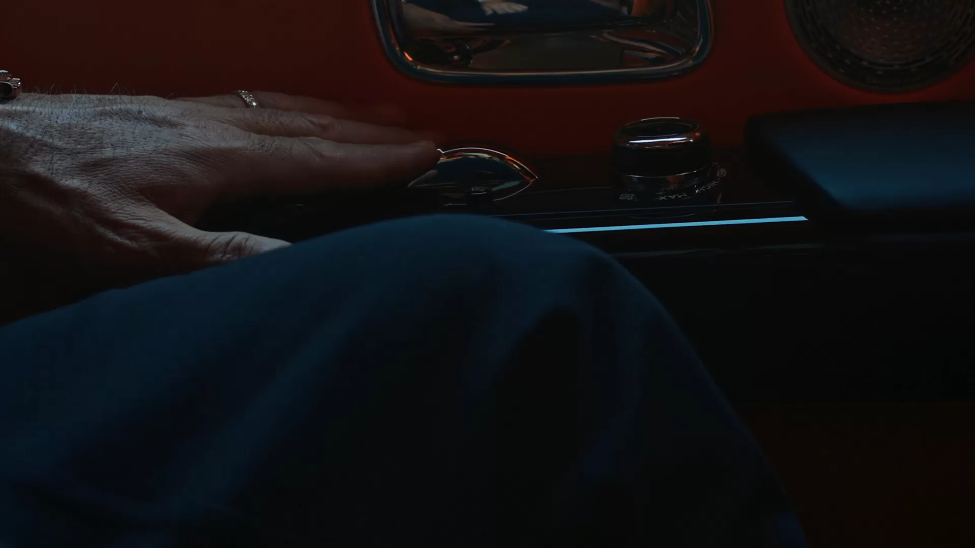 Ferris sitting in the rear of the car rolling down the window