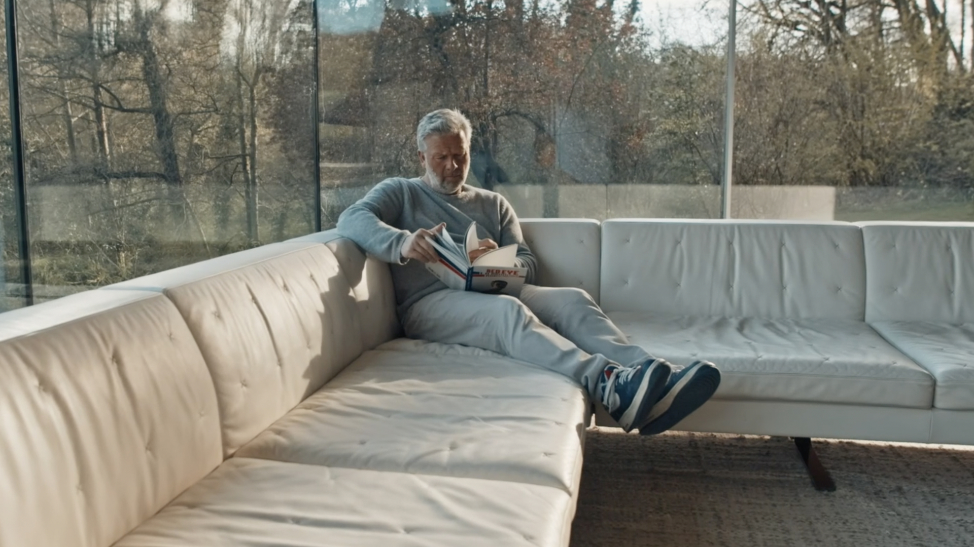 Richard Found reading a book in his sofa