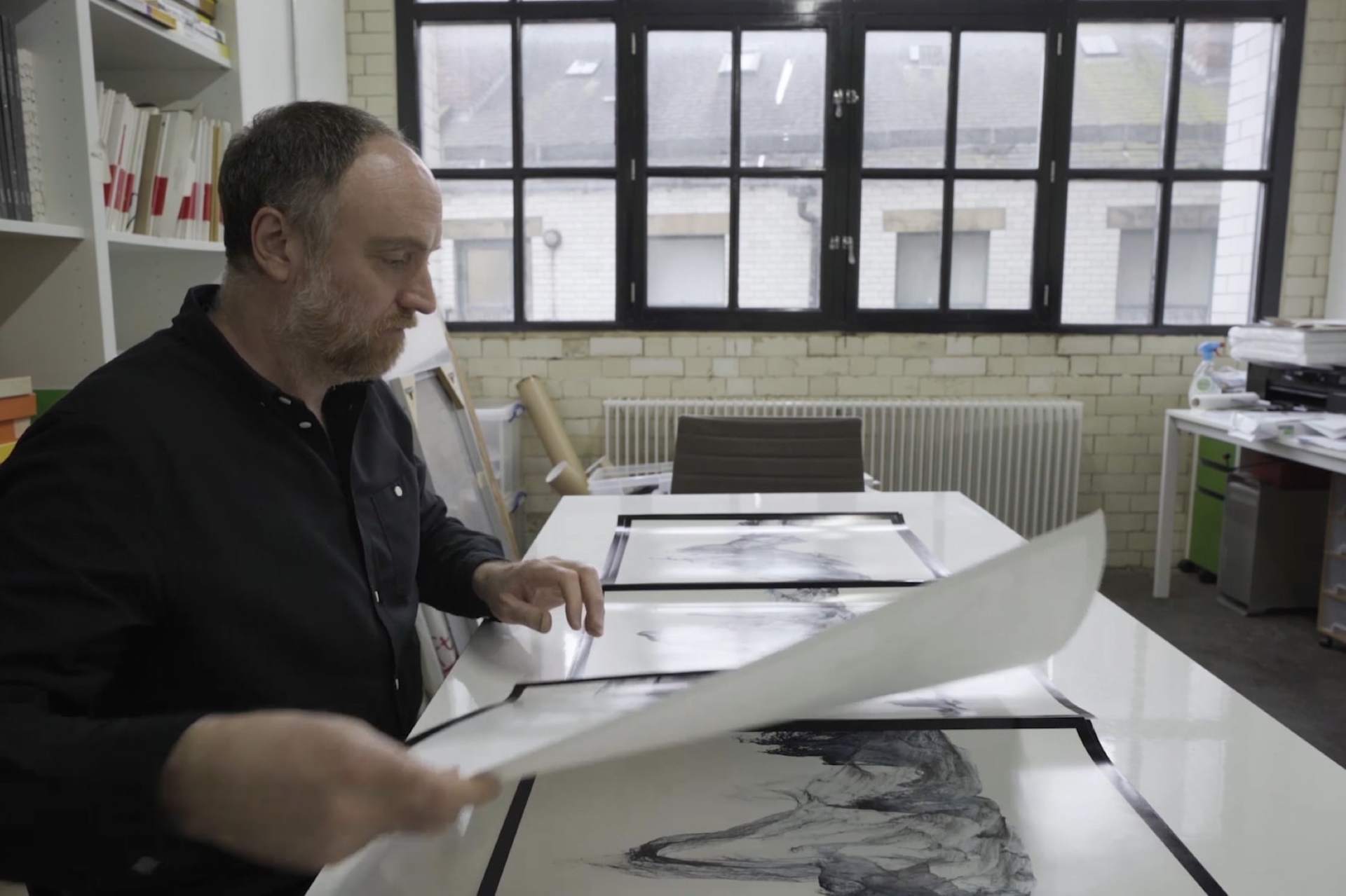 Artist Dan Holdsworth in his studio working on his glacier photographic art project.