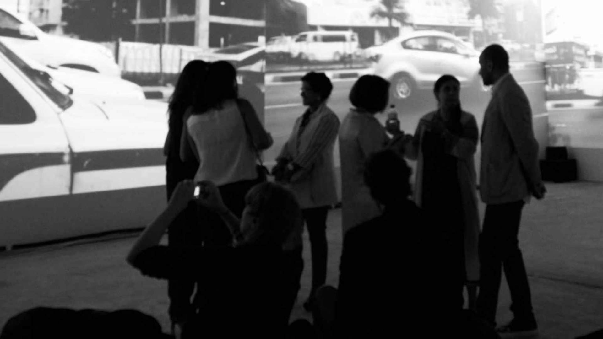 Manal Al Dowayan's installation titled I Had No Wings. His installation portrays a collection of photographs captured from the rear compartment of a car driving me around the streets of a city in Saudi Arabia