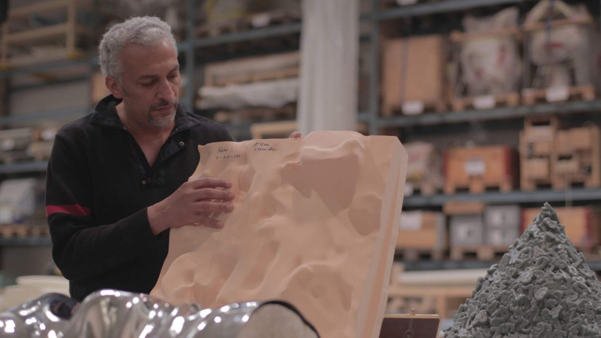 Mohammed Kazem working on one of his pieces using latitude and longitude co-ordinates.