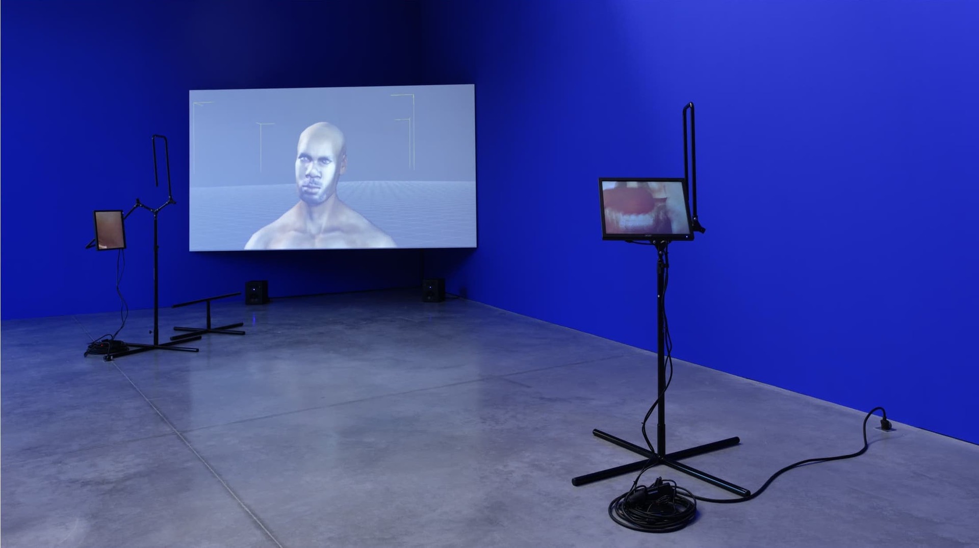 Still from the 'Its in the Game' piece - a projector screen with a 3d generated person from the torso up