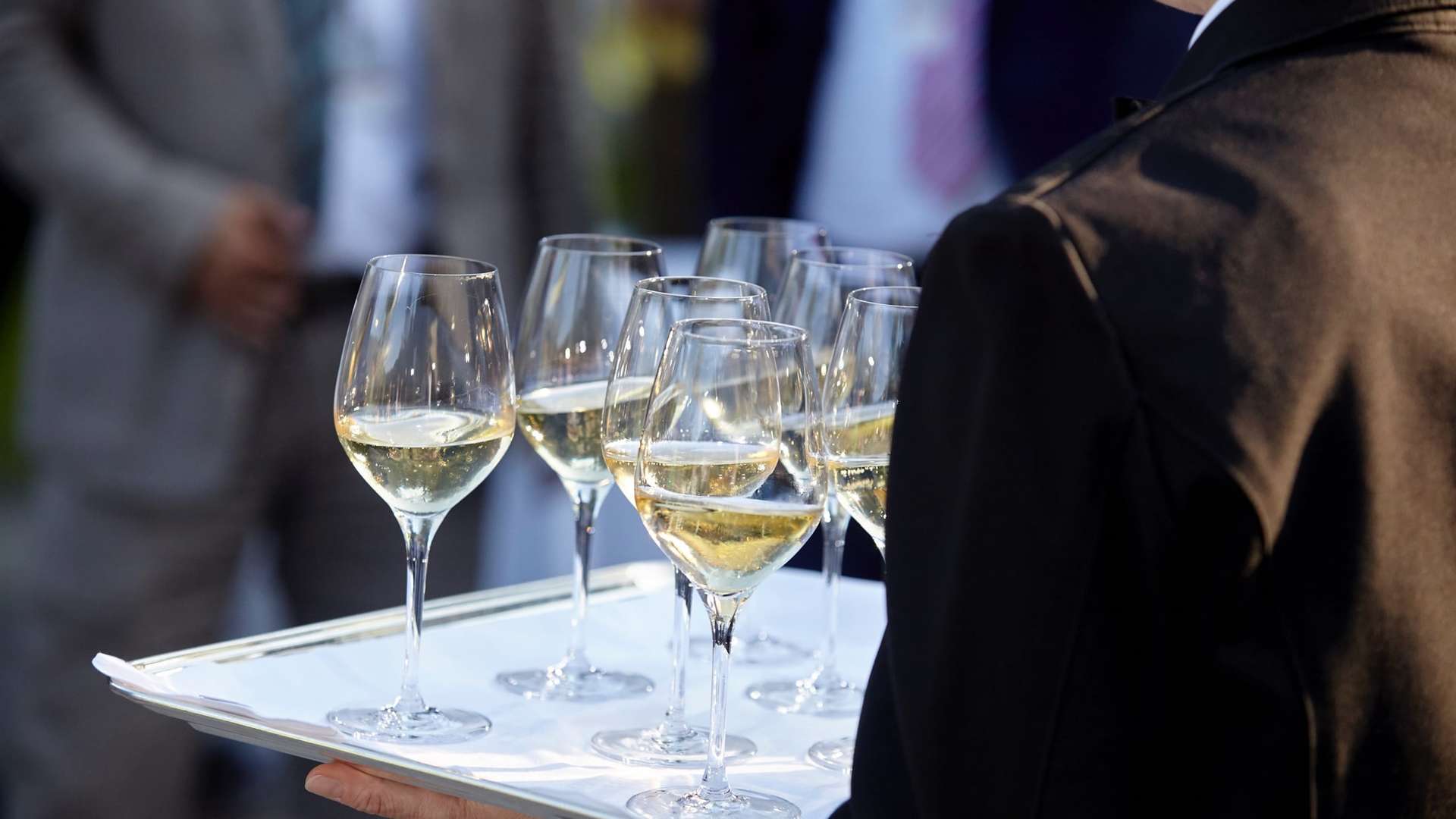 image of a waiter serving wine