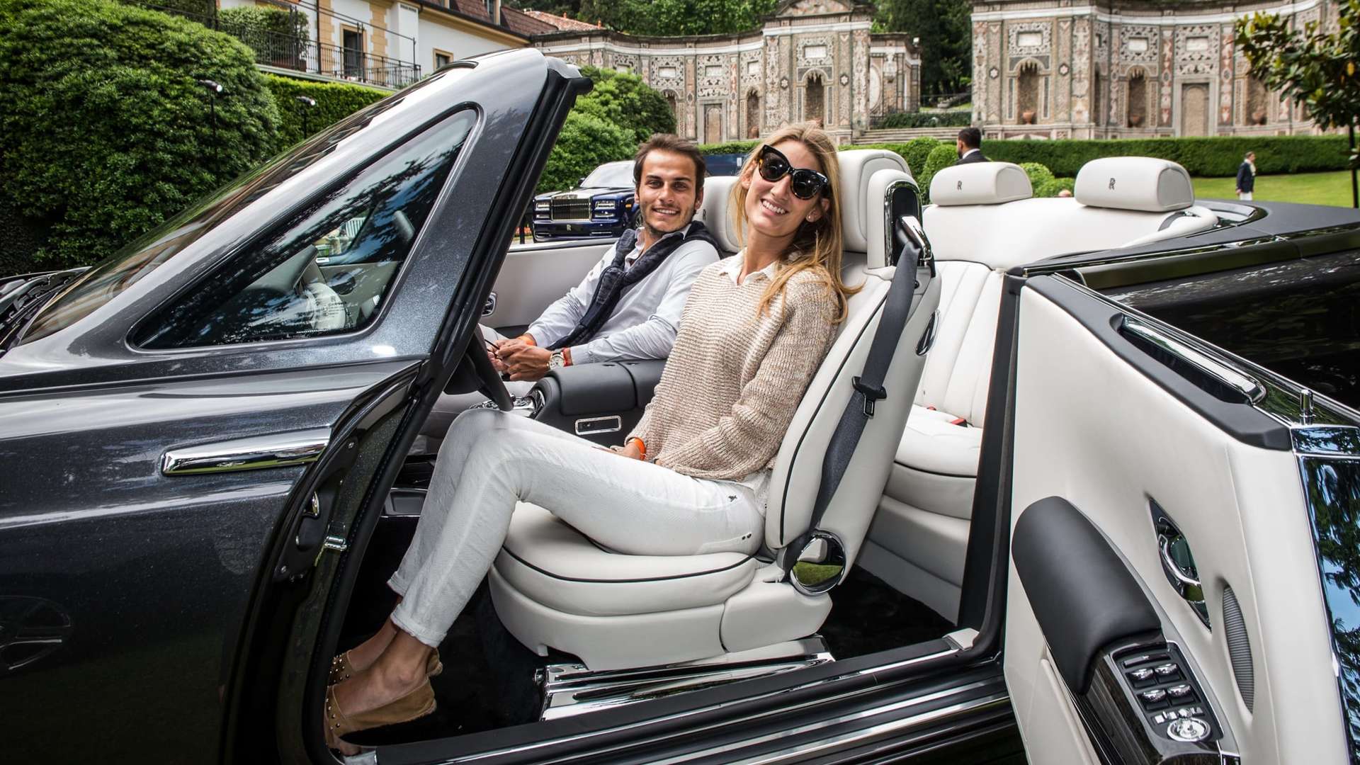 image of a happy couple in a rolls-royce dawn