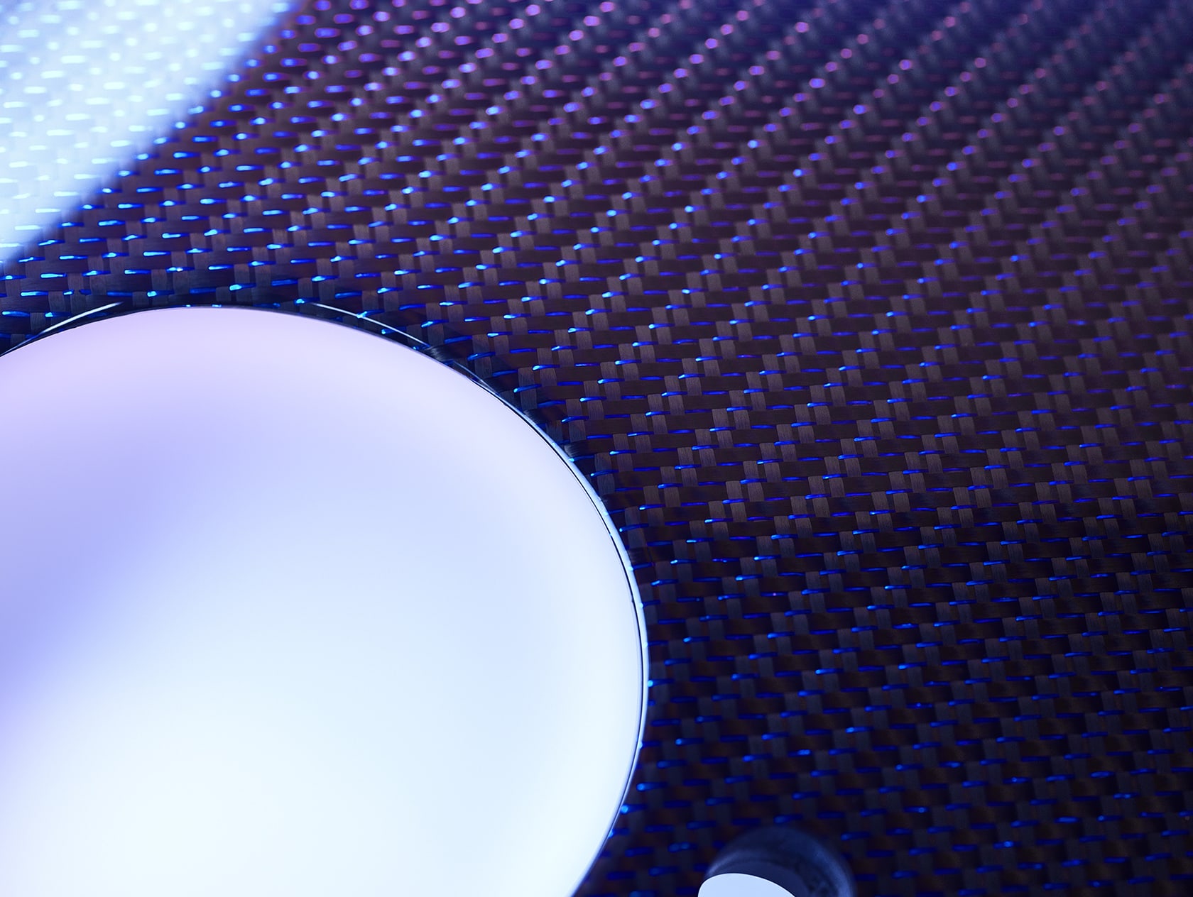 Close-up detail of Technical Weave, Rolls-Royce Bespoke's sparkling interpretation of carbon fibre, accented with tinted strands of aluminium thread