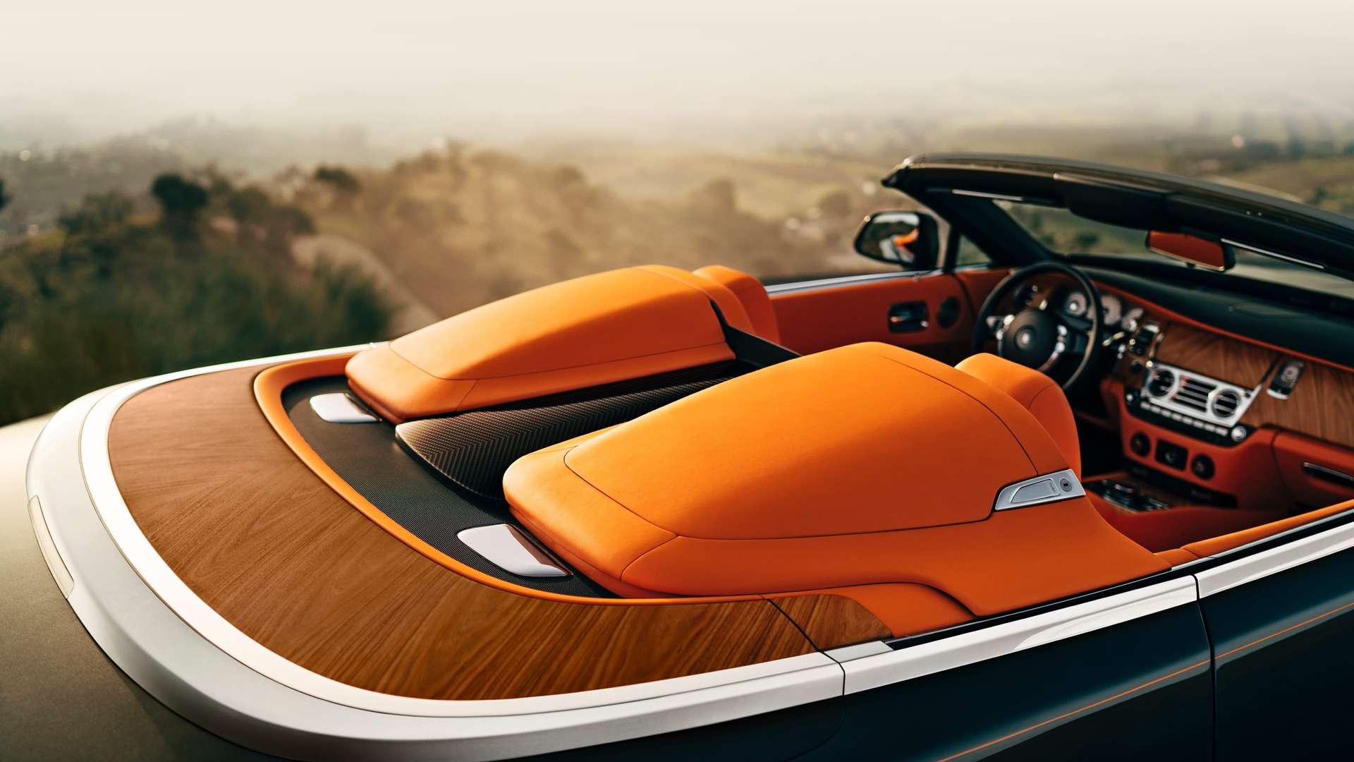 A close up of the orange leather interior on a convertible Rolls-Royce Dawn