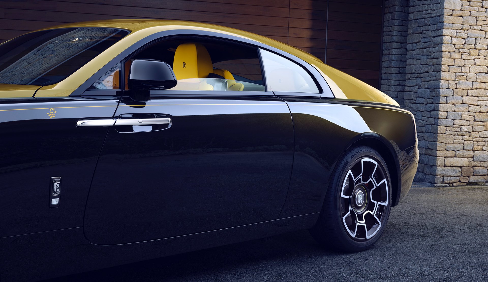 Exterior side view of parked bespoke Rolls-Royce motor car with personalised leather headrest