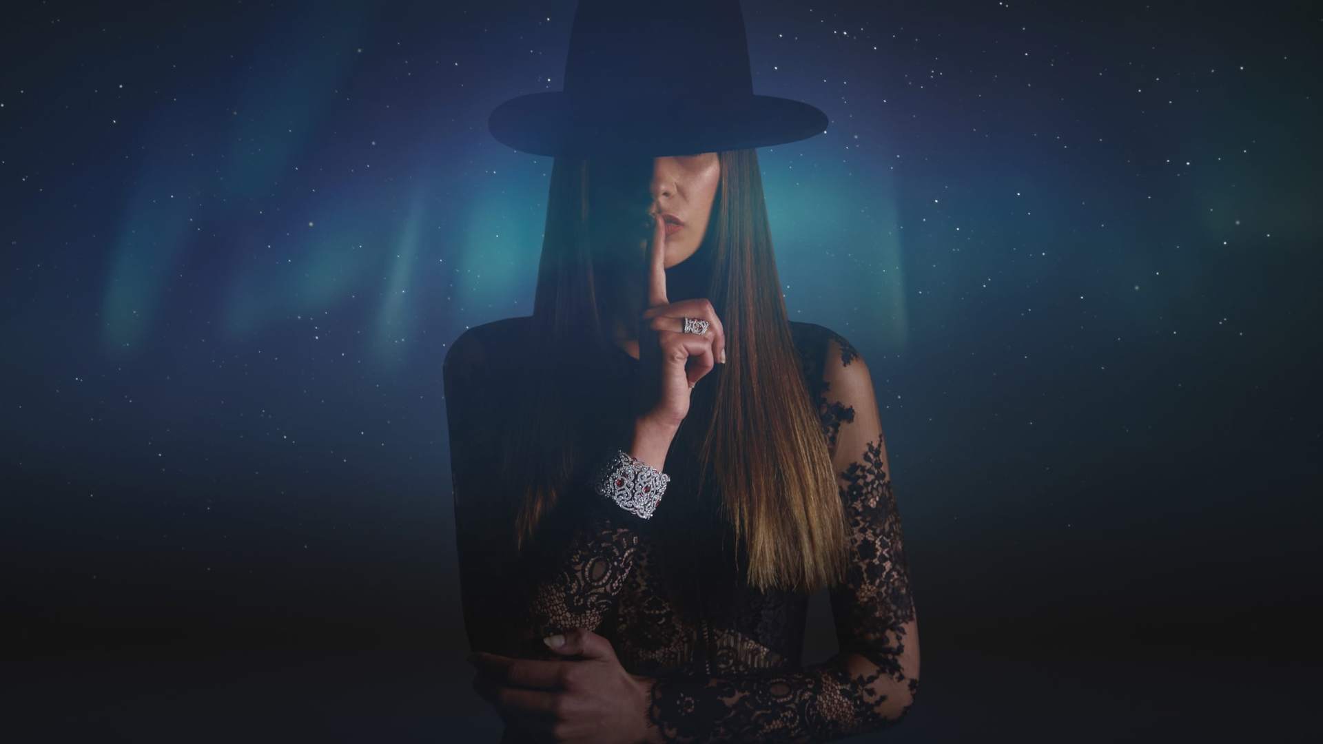 rolls royce phantom back side Woman wearing hat puts index finger on lips with starry night sky backdrop,