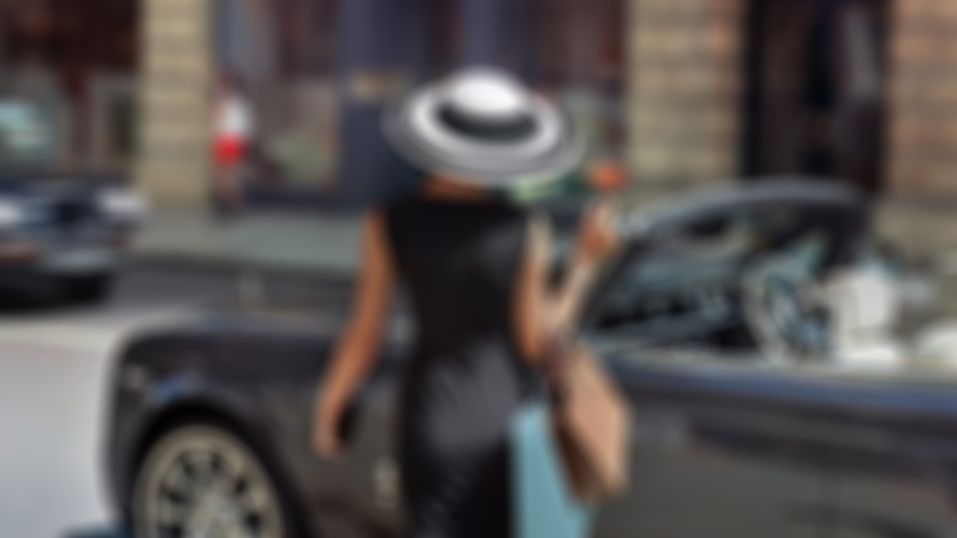 Stylish female in a Rachel Trevor Morgan hat approaches a Rolls-Royce Dawn with Pinstripe tyres