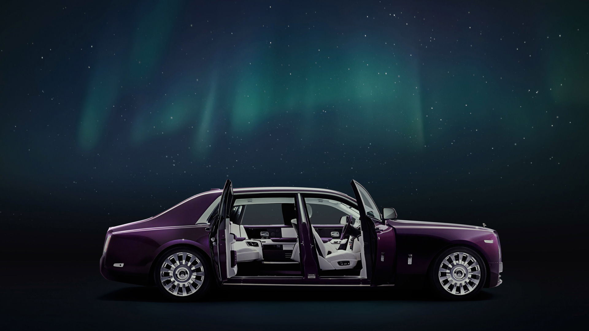 Side exterior view of the Rolls-Royce Phantom motor car with doors open with Aurora and night sky above