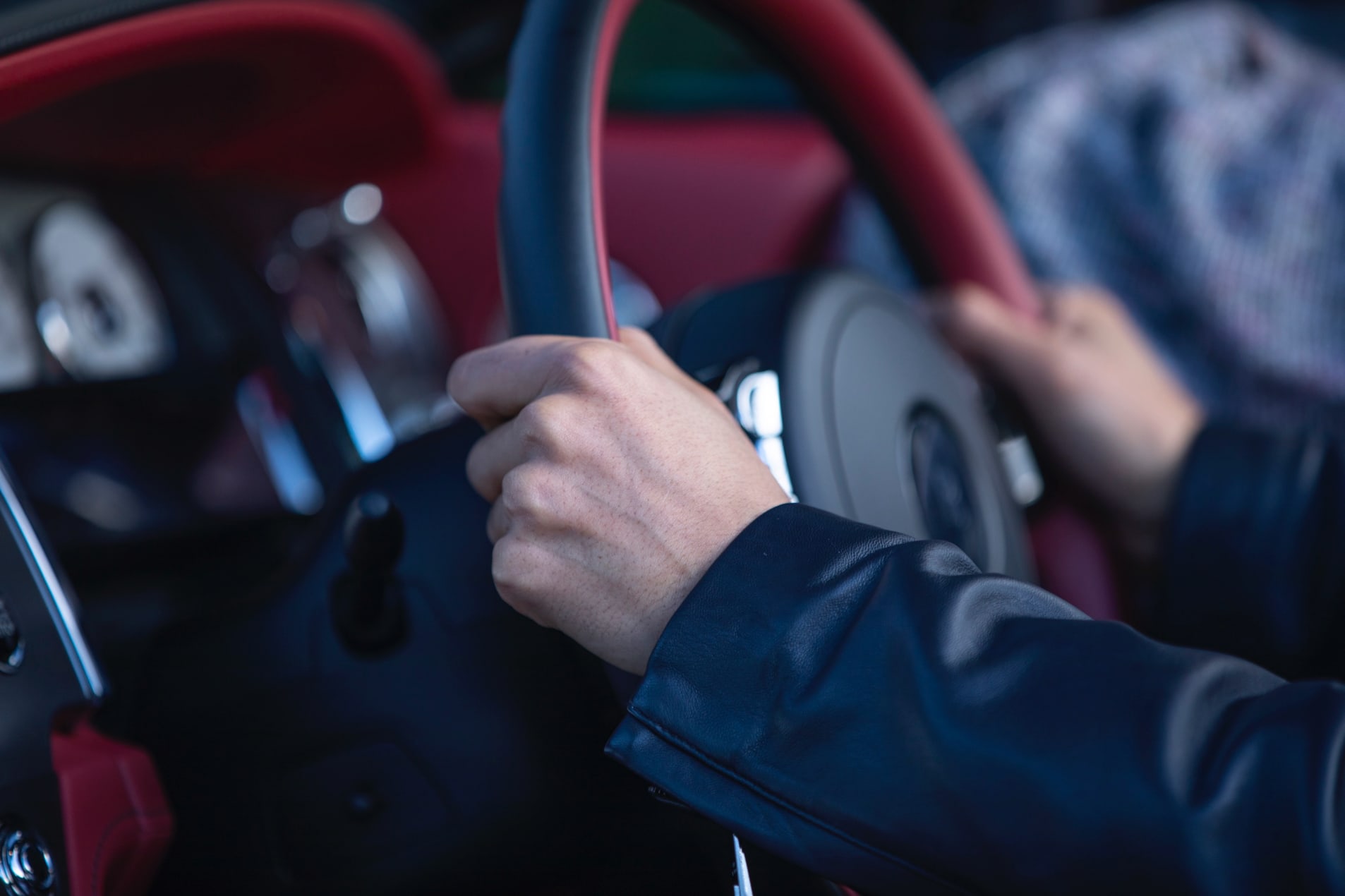 Close-up of hands on the steering wheel of the drophead coupé Rolls-Royce Dawn motor car