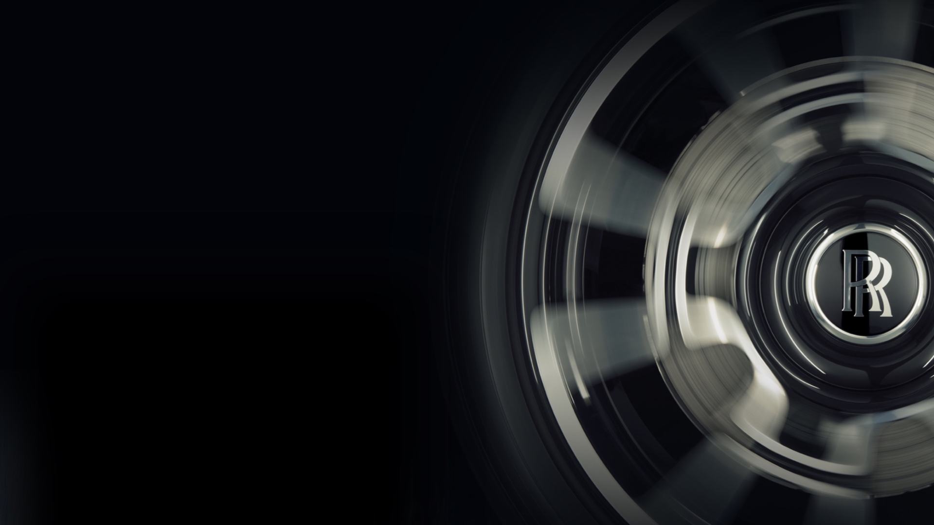 A zoomed image of Rolls-Royce wheel while in motion.