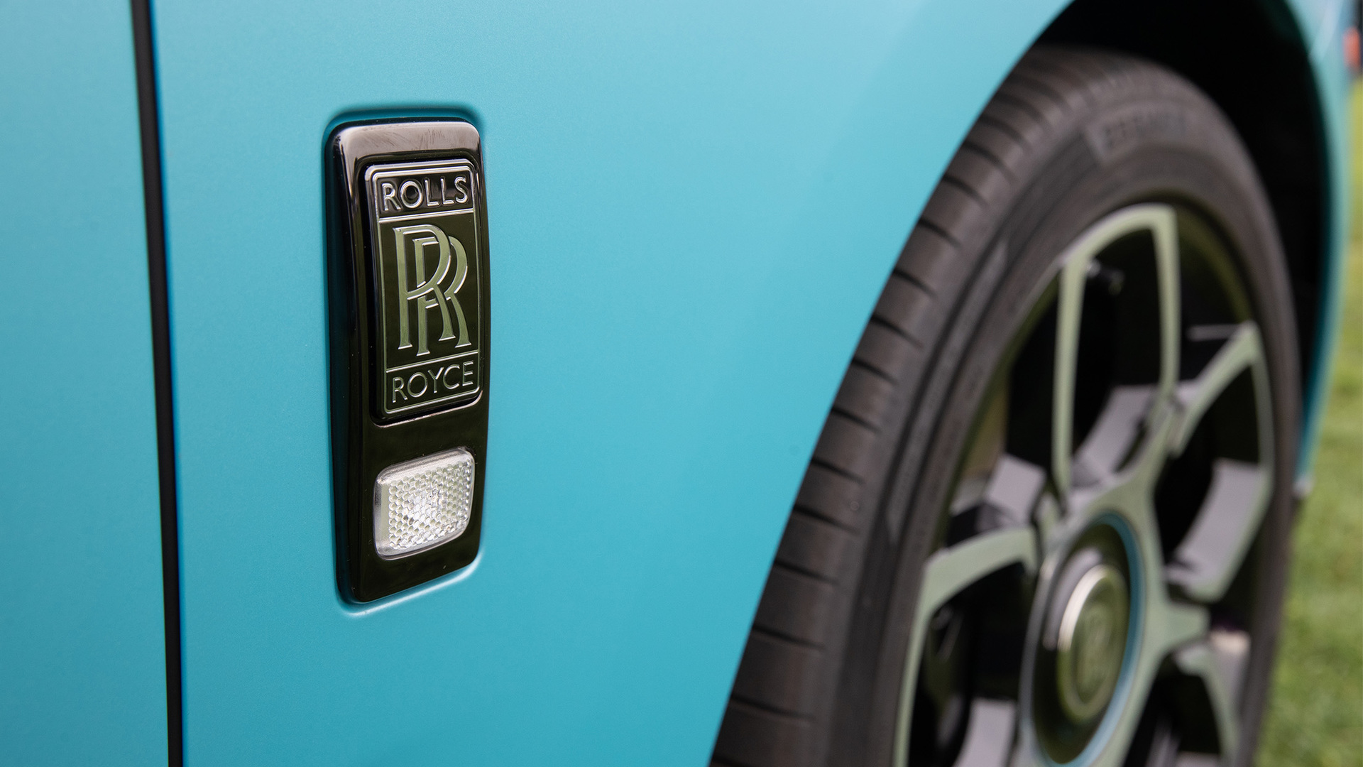 RR logo against blue coloured Black Badge Cullinan