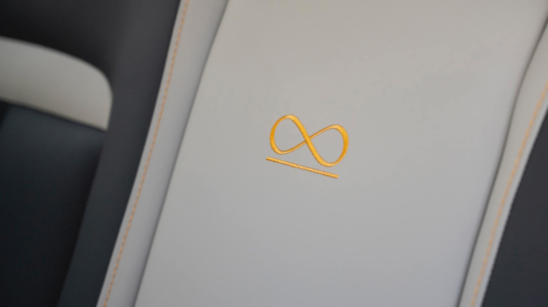 Black Badge Infinity Loop signature symbol detailing in the bespoke Rolls-Royce Black Badge Cullinan Capella motor car