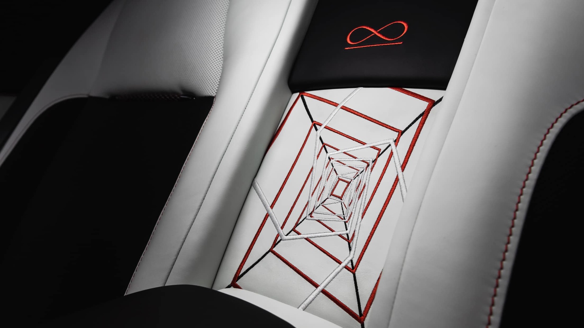 Bespoke rear passenger seat embroidery and Black Bade Infinity loop signature symbol in Koi Red accents 