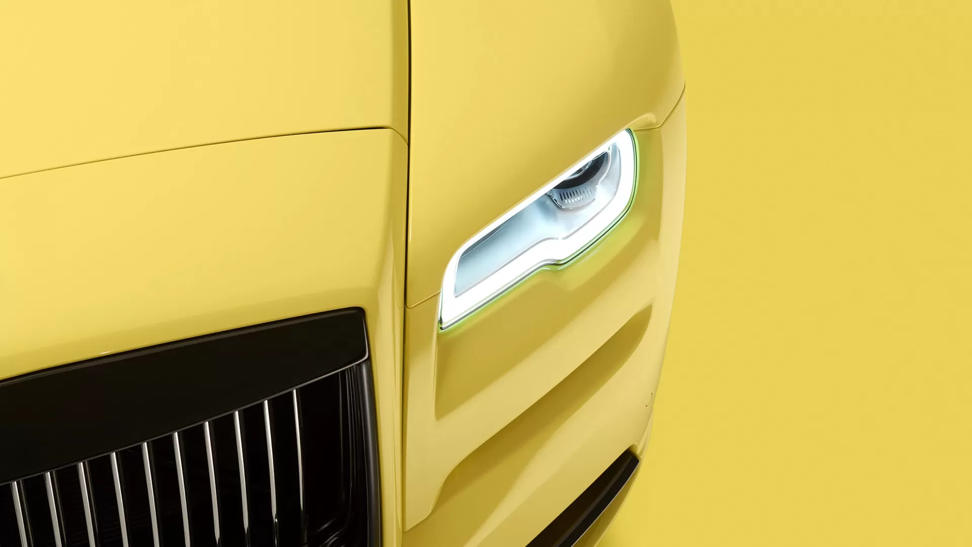 Headlight shot of yellow Rolls Royce Wraith