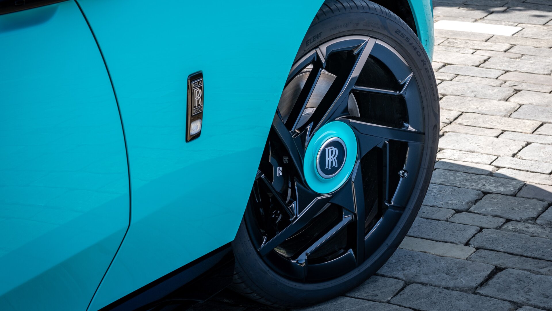 Close up of a blue pastel bespoke black badge model