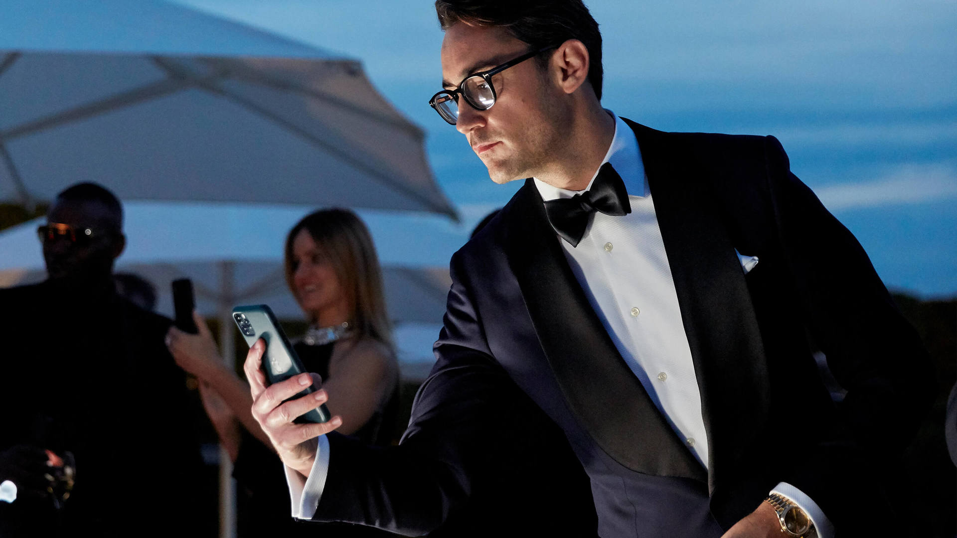 Man with phone in hand for Rolls-Royce Whispers Explore