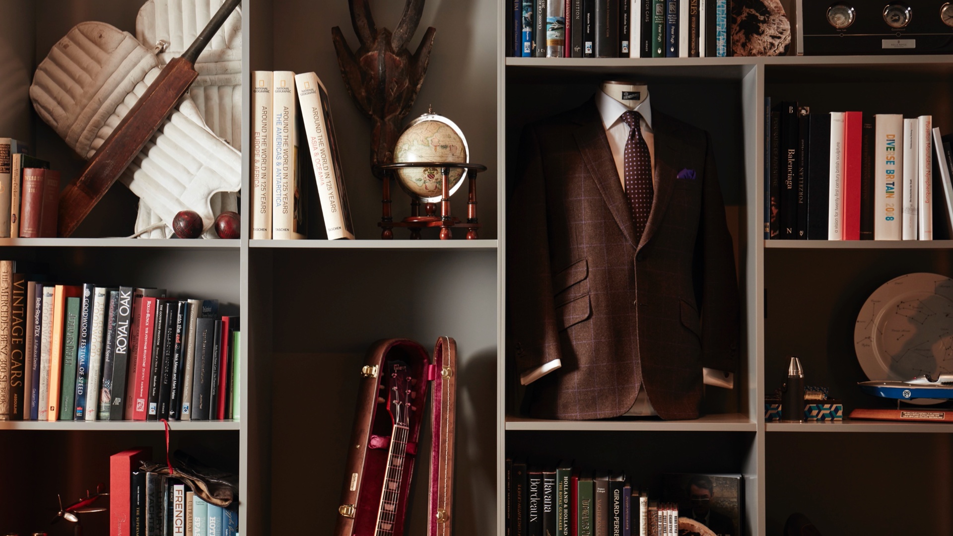 A number of items, including a suit, a globe some books and a musical instrument used as influence by the Rolls-Royce designers