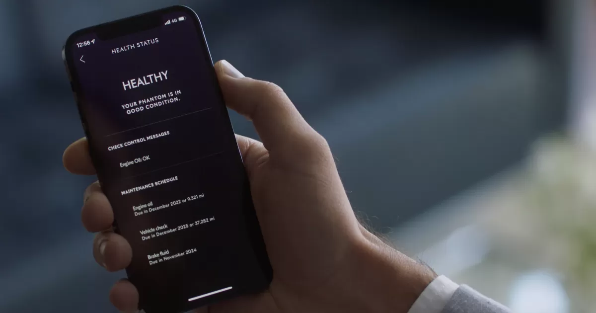 A customer checking the health of its Rolls-Royce car on its phone