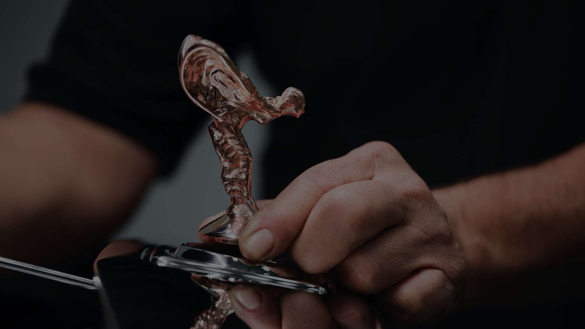 A technicial working on a Spirit of Ecstasy