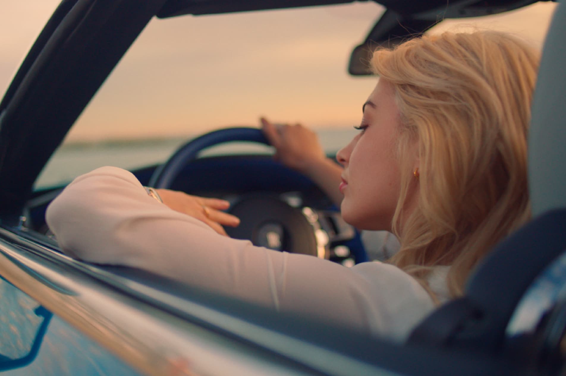 Woman driving Rolls-Royce motor car
