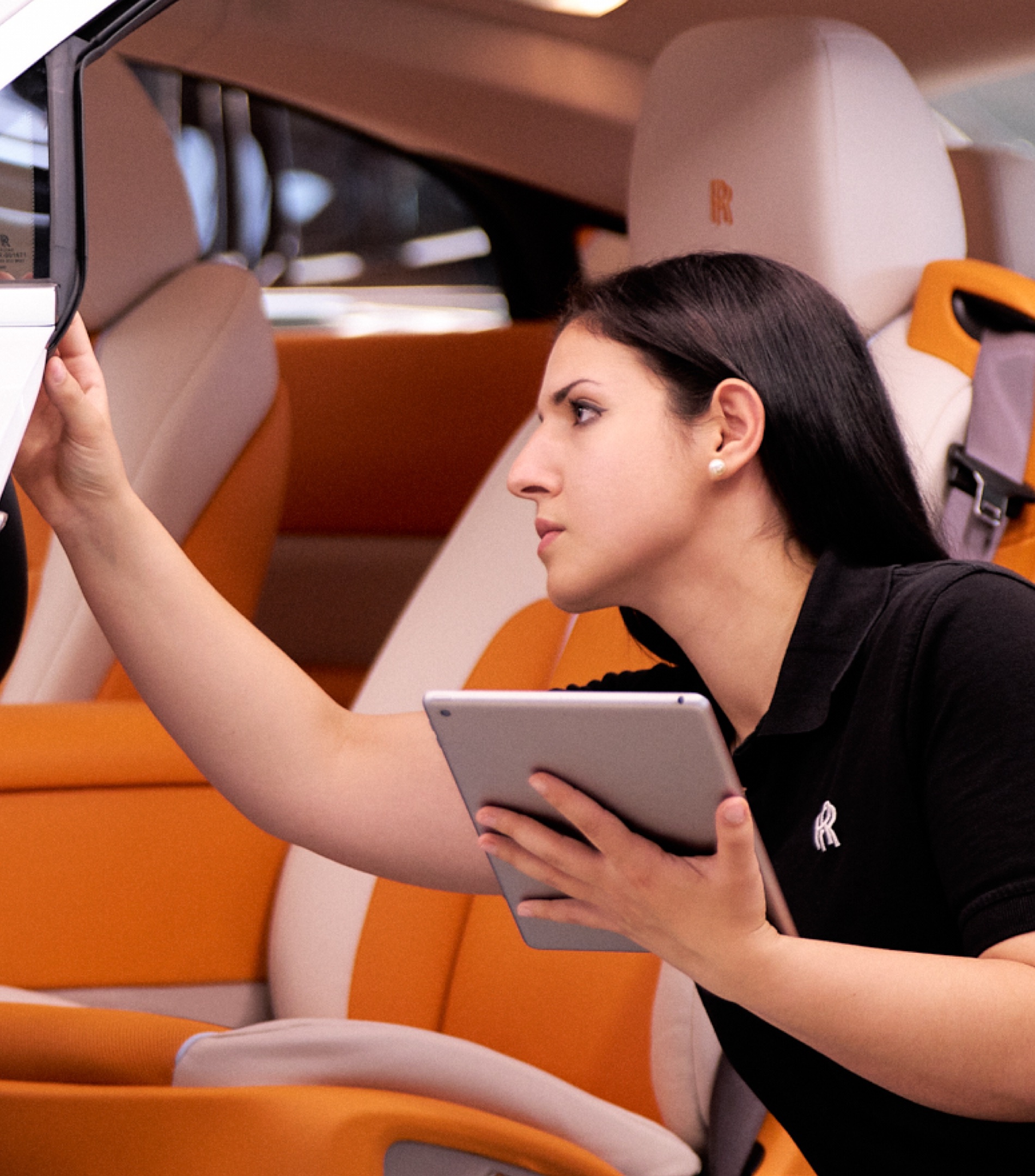 A female Rolls-Royce graduate checking the details of the interior or a Rolls-Royce car