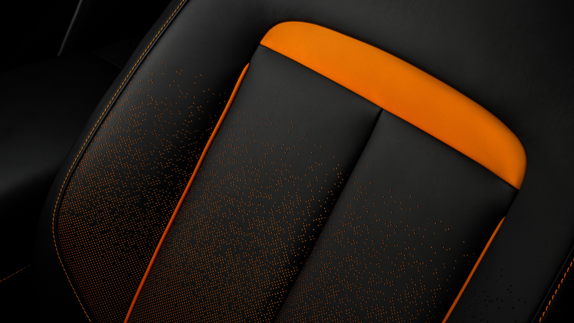Close up of Black Badge Ghost Ekleipsis black and orange perforated seat