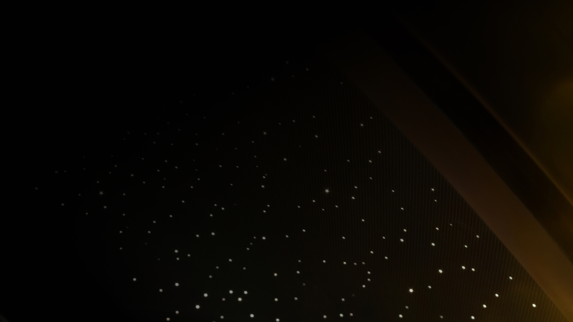 Black background with white Rolls Royce lights.