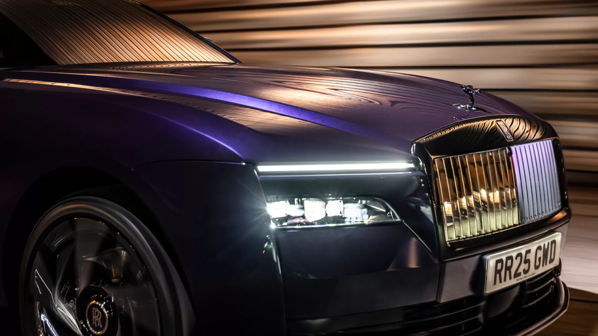 Close up - front wheel shot of the purple Black Badge Spectre ascending up the road, showcasing the beautiful Spectre rims. 