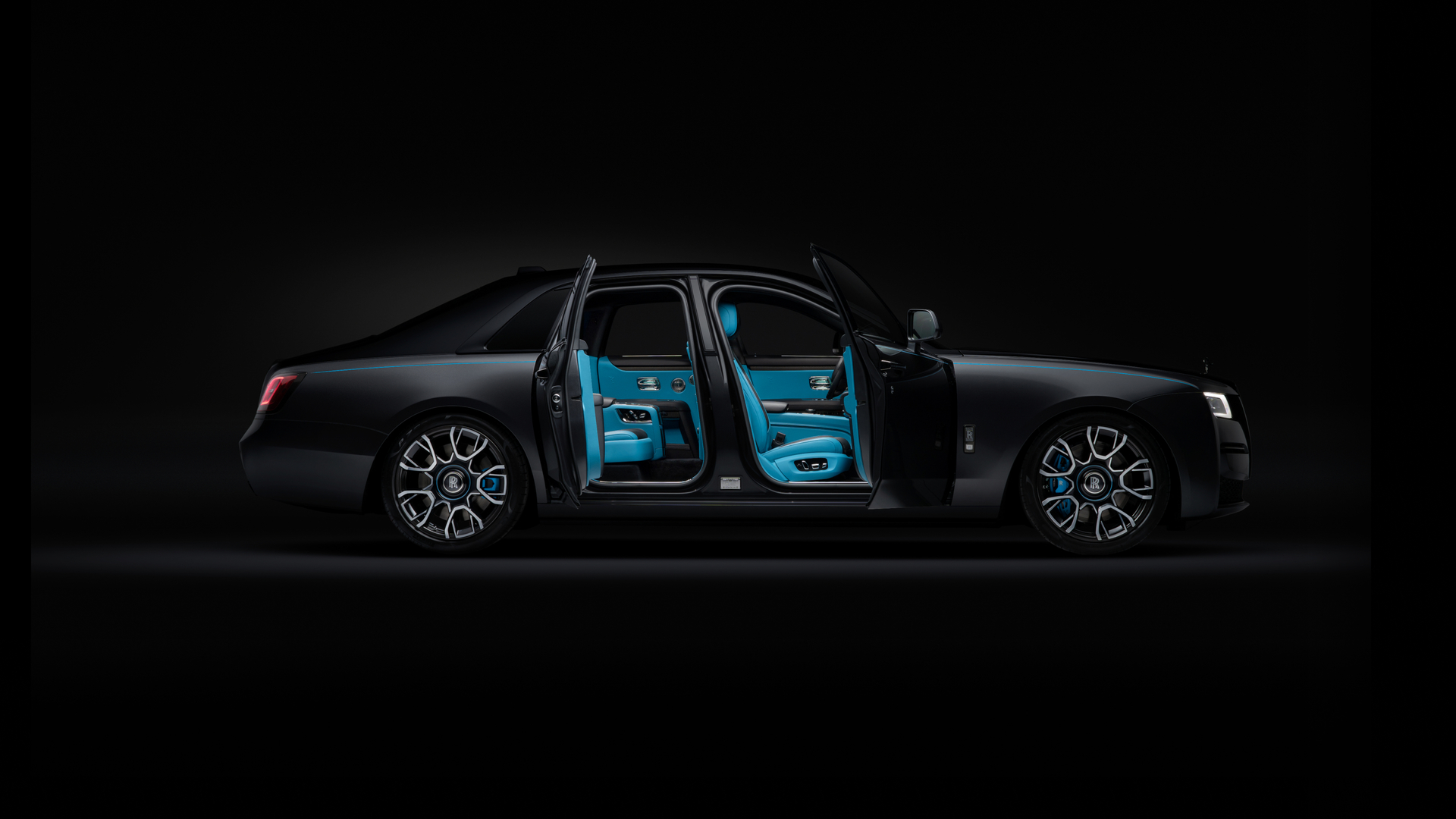 Rolls Royce Black Badge Ghost with it's doors open displaying a blue interior