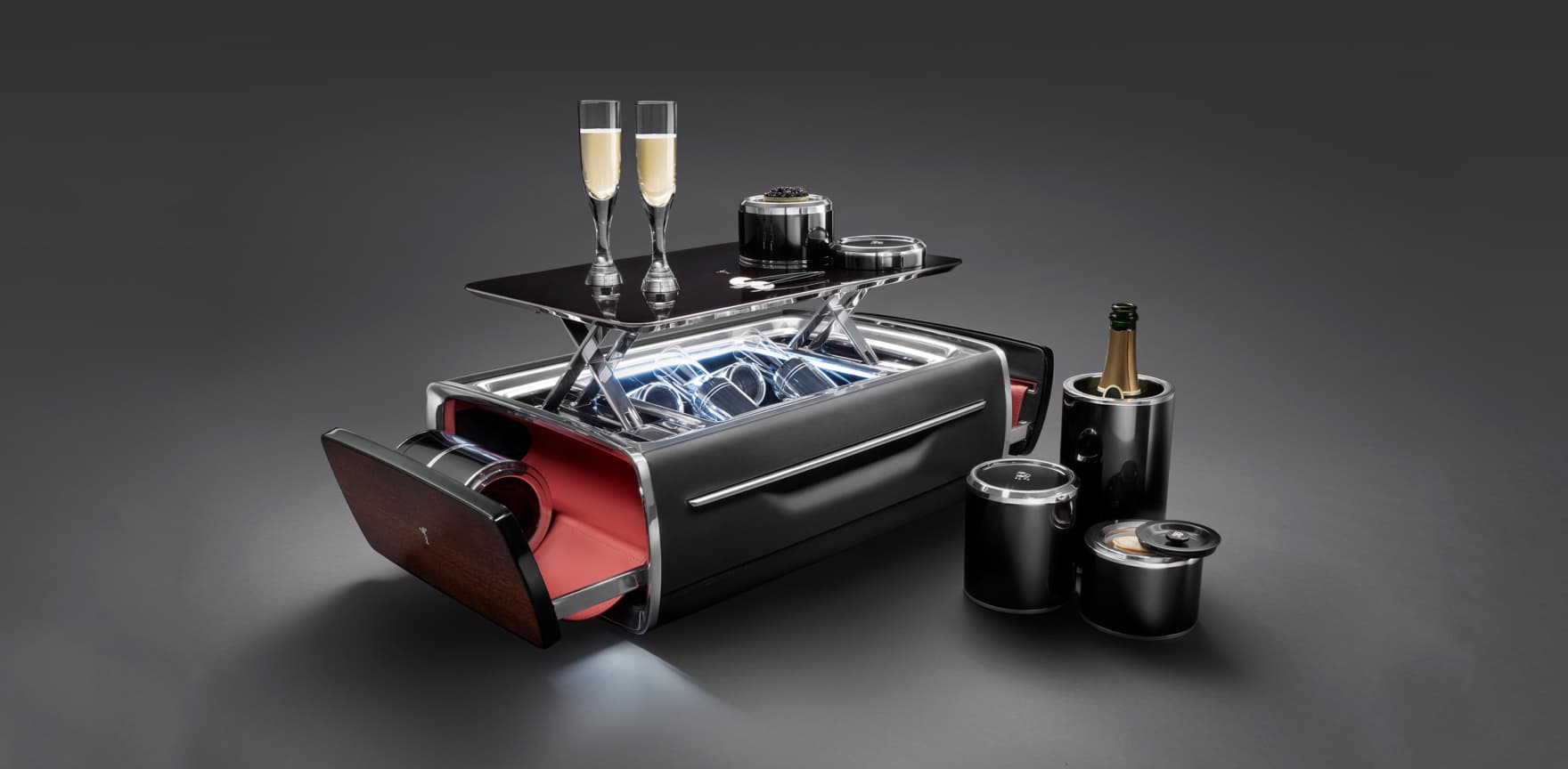 The Rolls-Royce Champagne Chest effortlessly opens at the push of a button to reveal a perfectly appointed champagne set