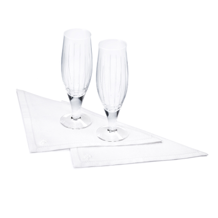 <p>Enjoy these Champagne Flutes and napkins in any setting. Along with the fine glass of the flutes, the napkins come with decorative stitching around boarder.</p>