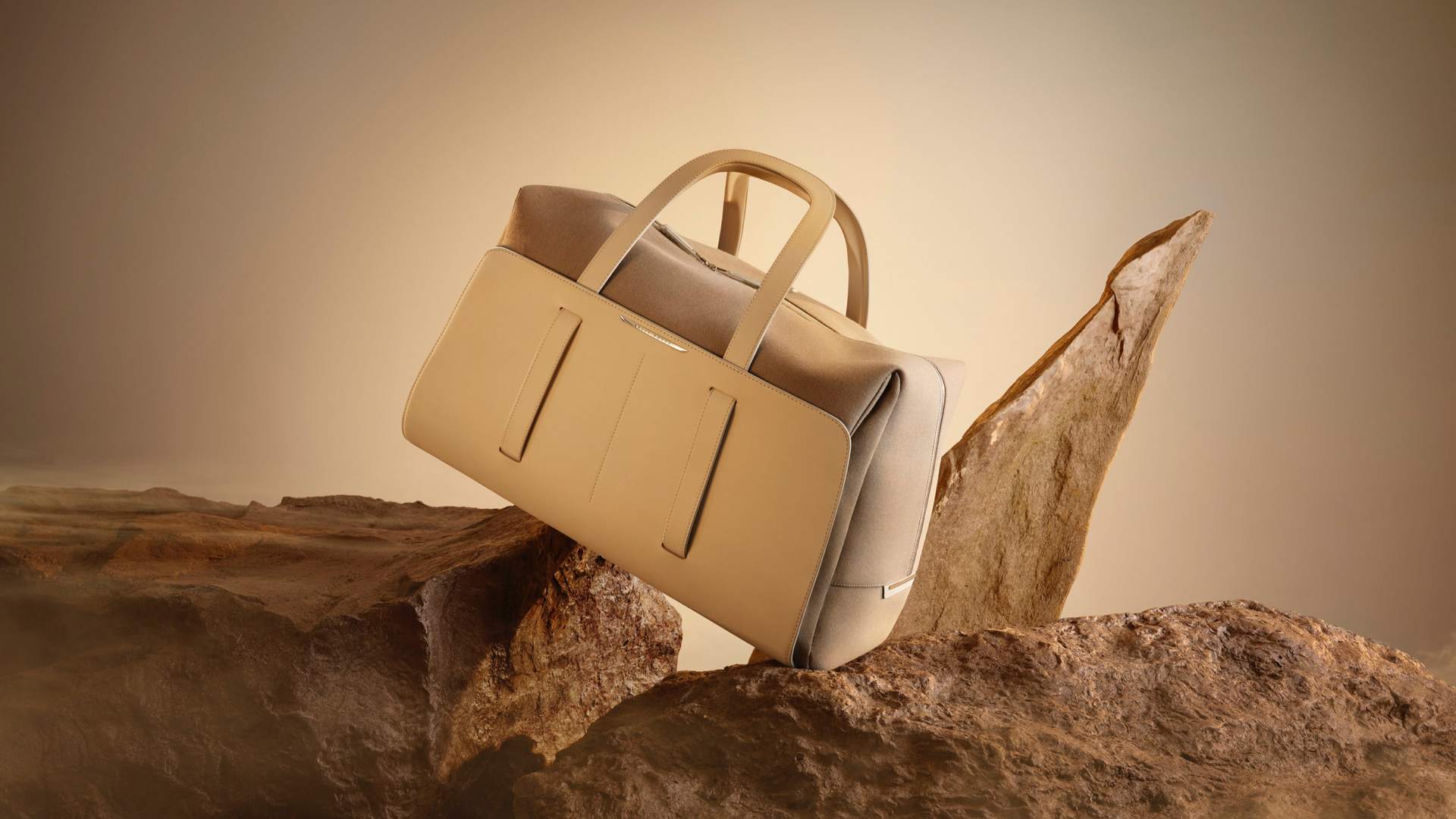 48 hr Weekender bag from the Rolls-Royce Escapism Luggage Collection balancing on sharps rocks