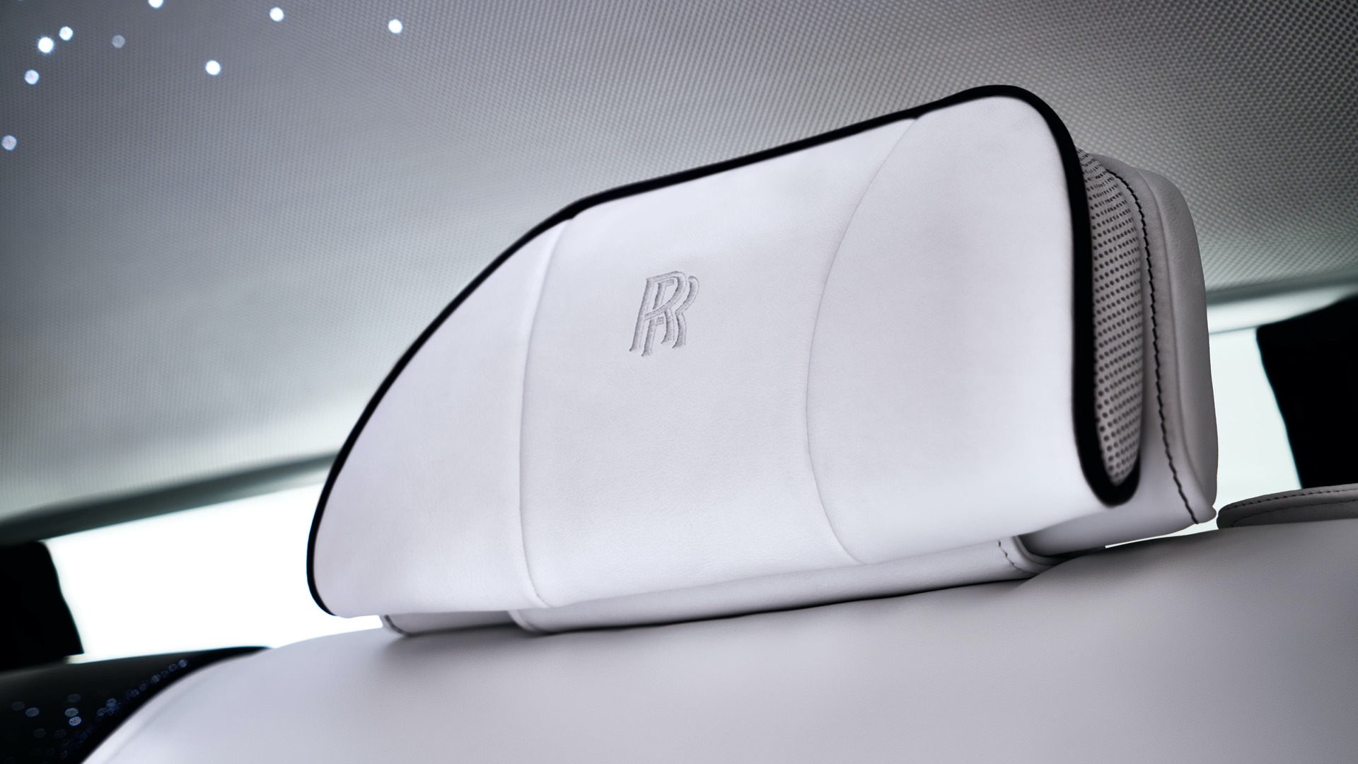 Rolls-Royce motor car white headrests with conform cushions and elegantly embroidered Rolls-Royce logo,