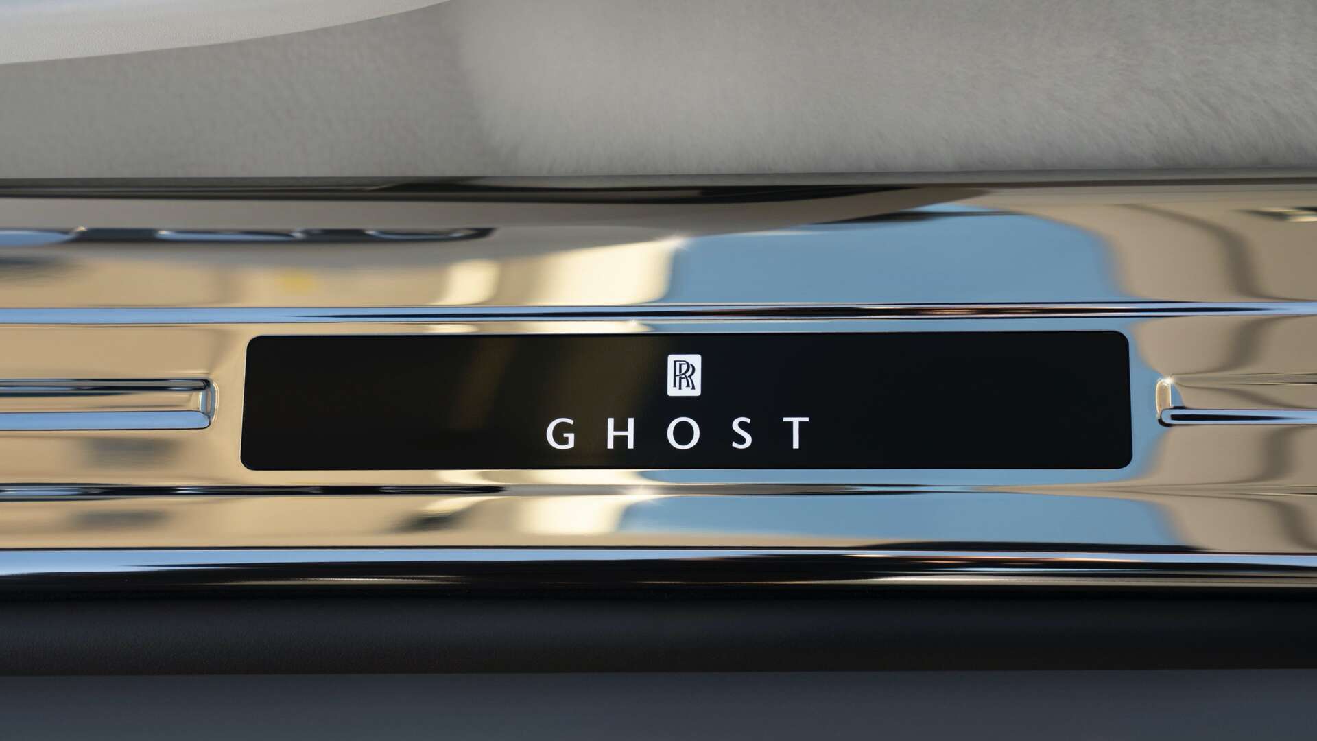 An interior shot of a Rolls-Royce motor car Ghost with an illuminated treadplate.