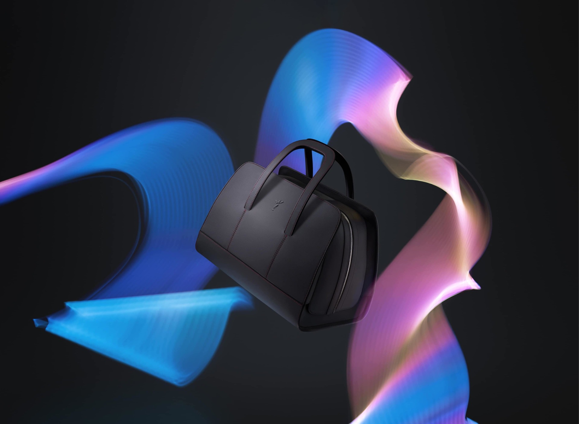 The Long Weekender in black from the Rolls-Royce Kinetic luggage collection floats above abstract flowing colours