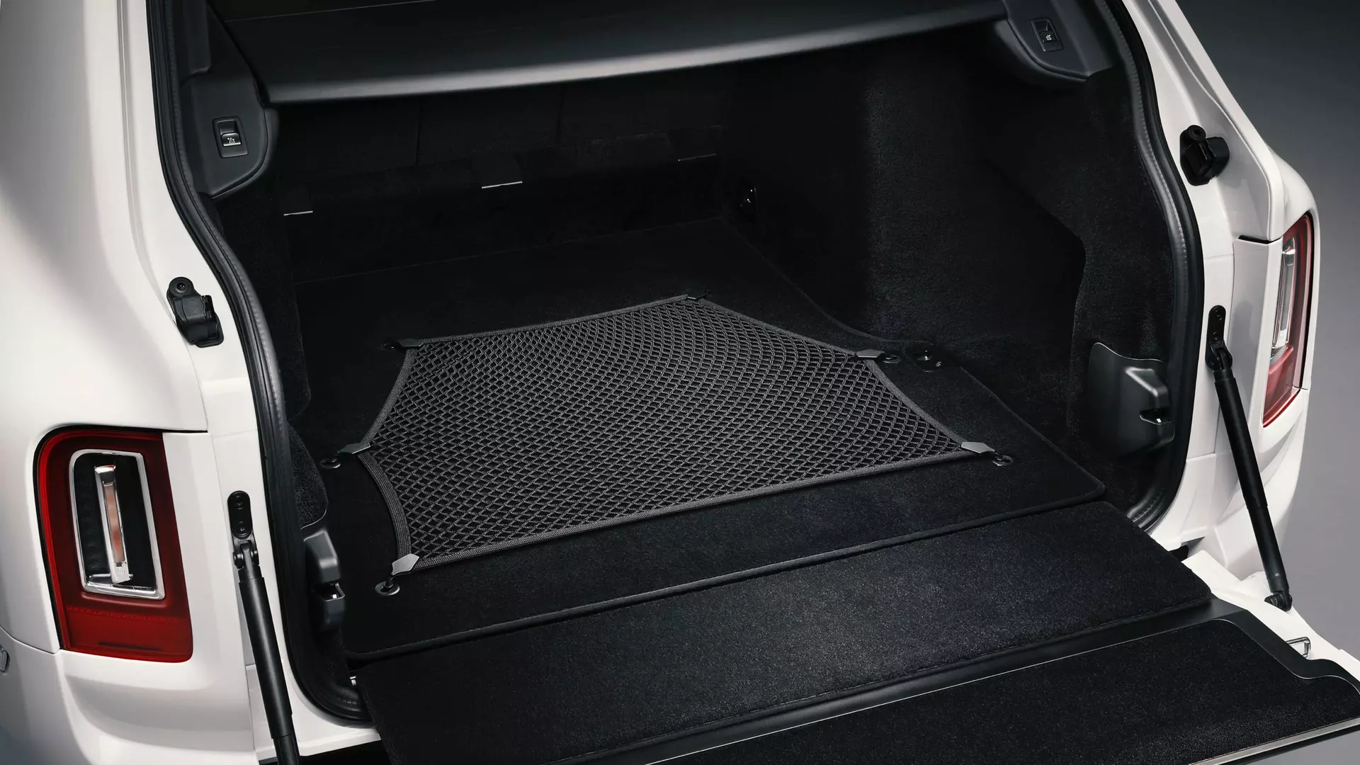 Rolls-Royce Cullinan motor car with rear door open revealing durable luggage net