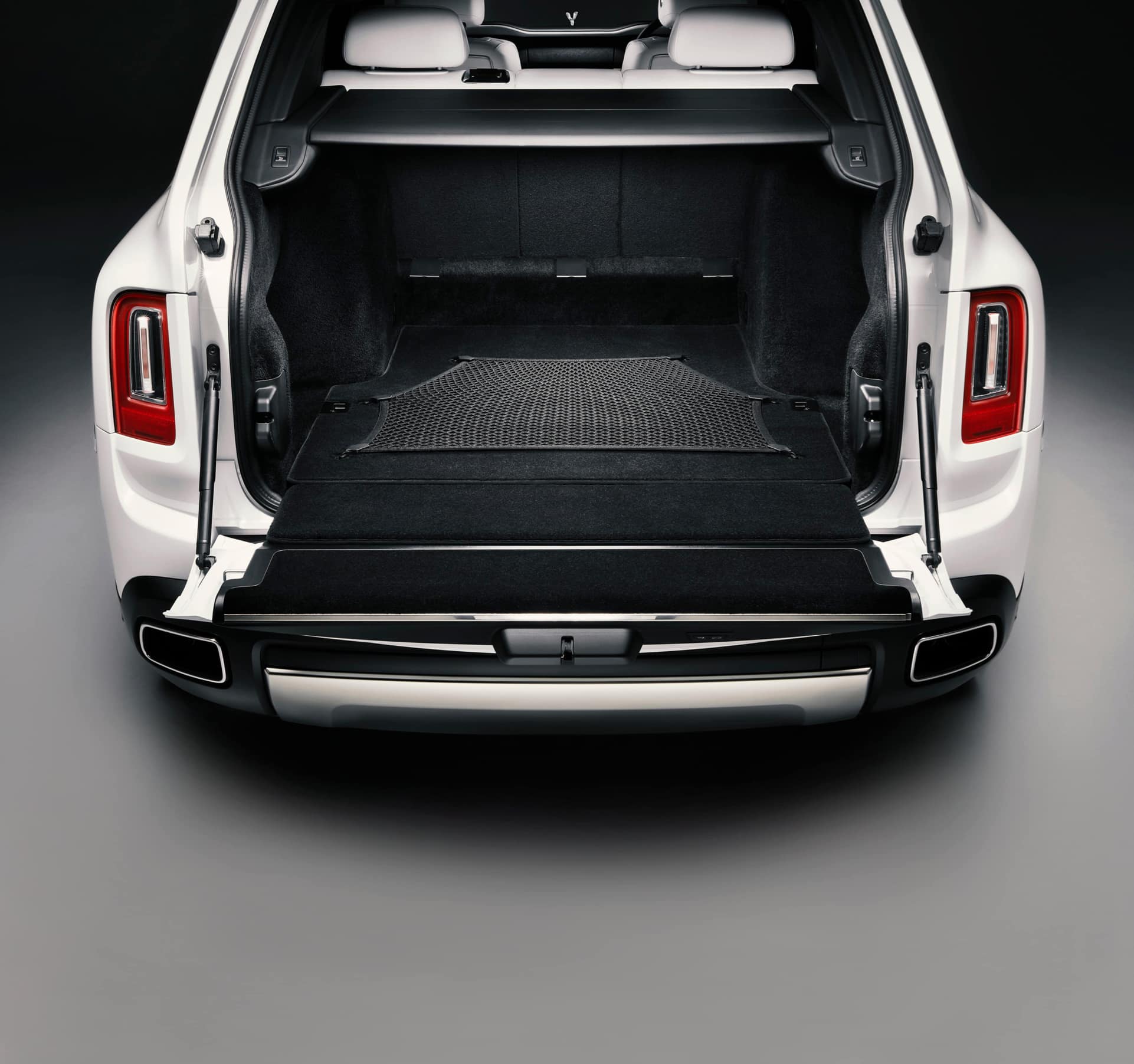 Rolls-Royce Cullinan motor car with rear door open revealing durable luggage net