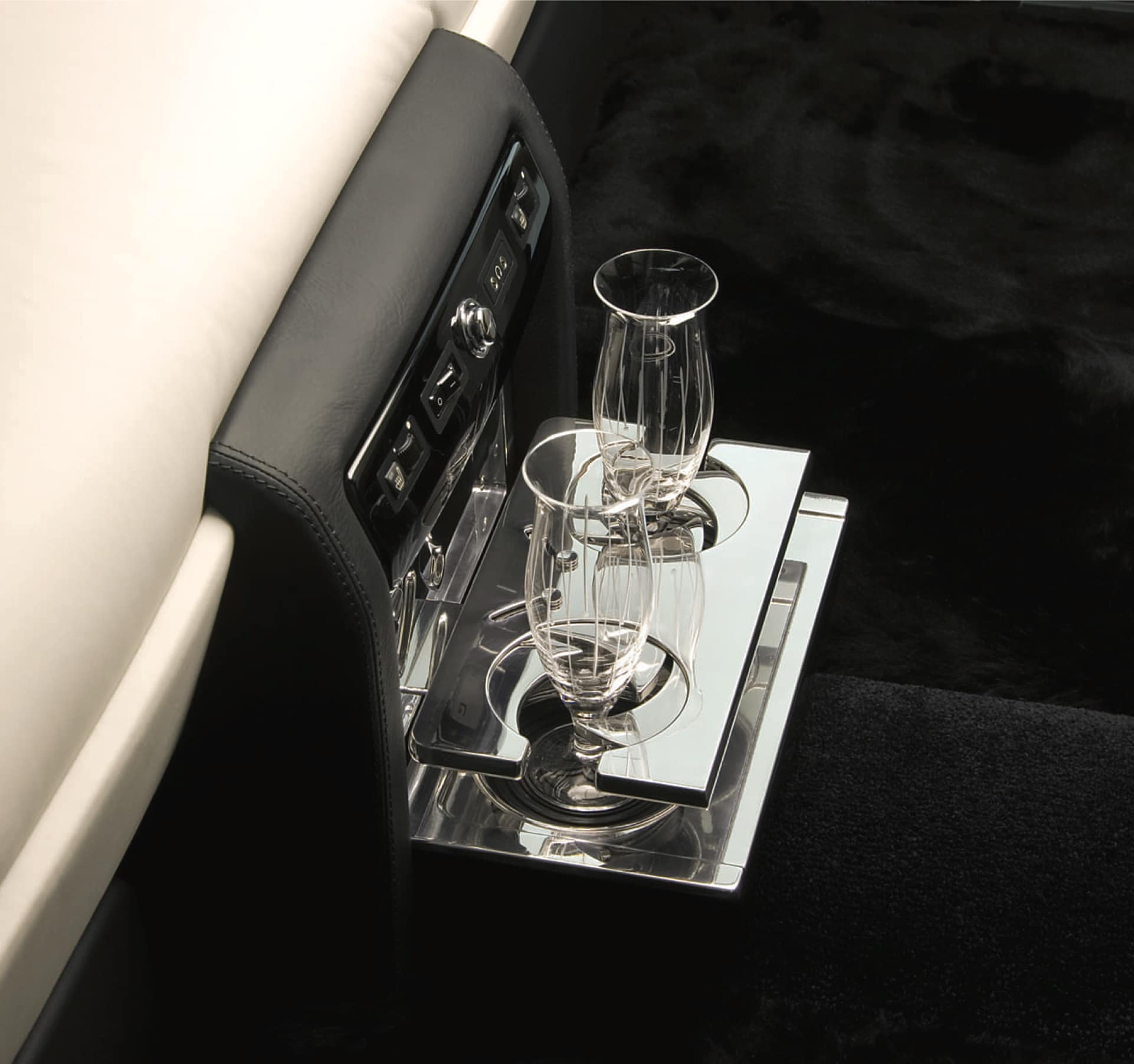 Interior of Rolls-Royce motor car with dual drinks holder engineered, milled and polished from solid aluminium