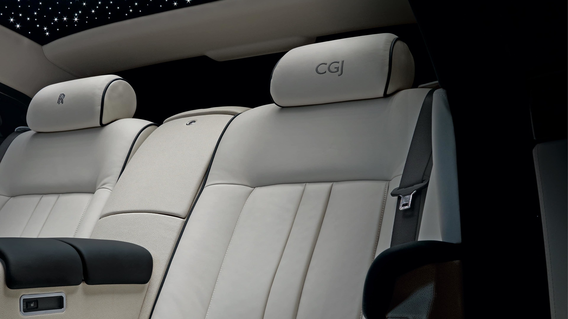 Interior of Rolls-Royce motor car with starlight headliner and personalised headrests 