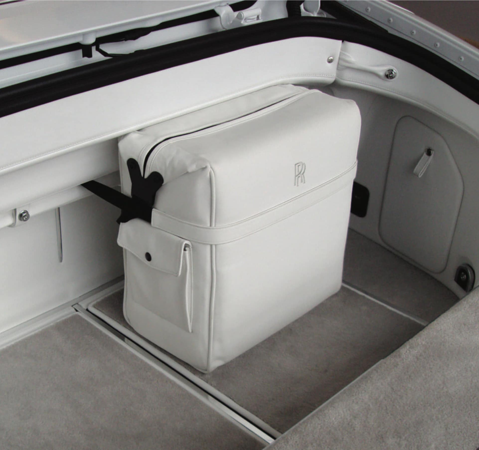 Luggage compartment of Rolls-Royce motor car with portable coolbag trimmed with leather to match the vehicle’s interior