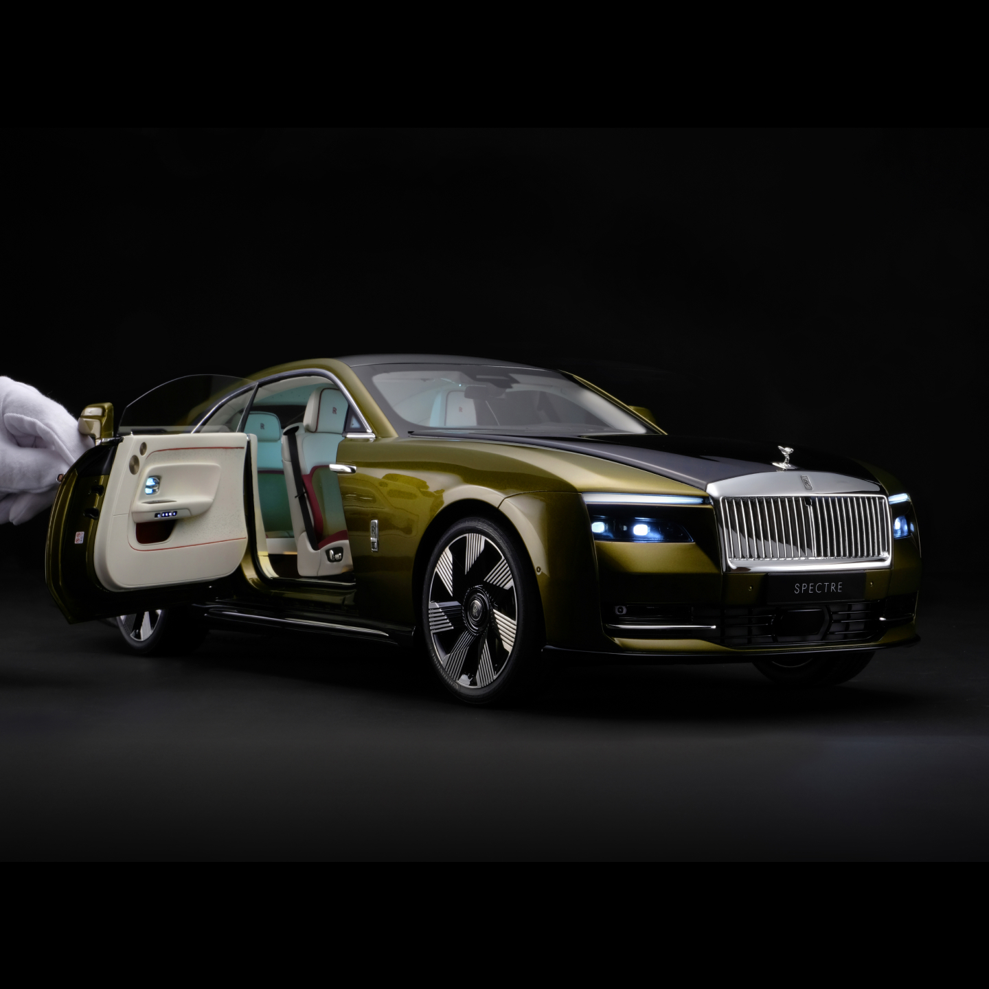 1:8 scale model of the Rolls-Royce Spectre motor car with hand holding door open