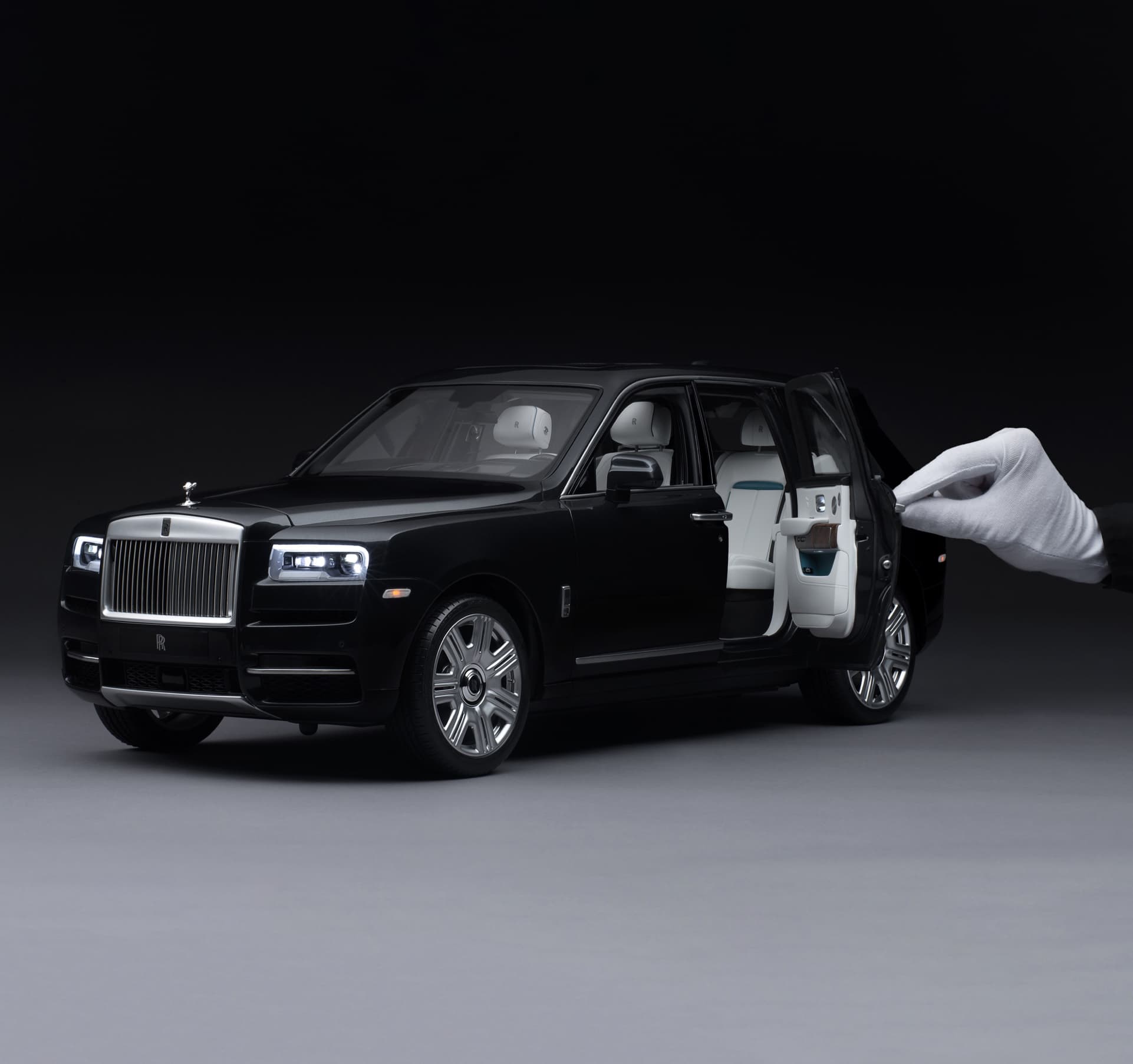 1:8 scale model of the Rolls-Royce Cullinan motor car with hand holding door open