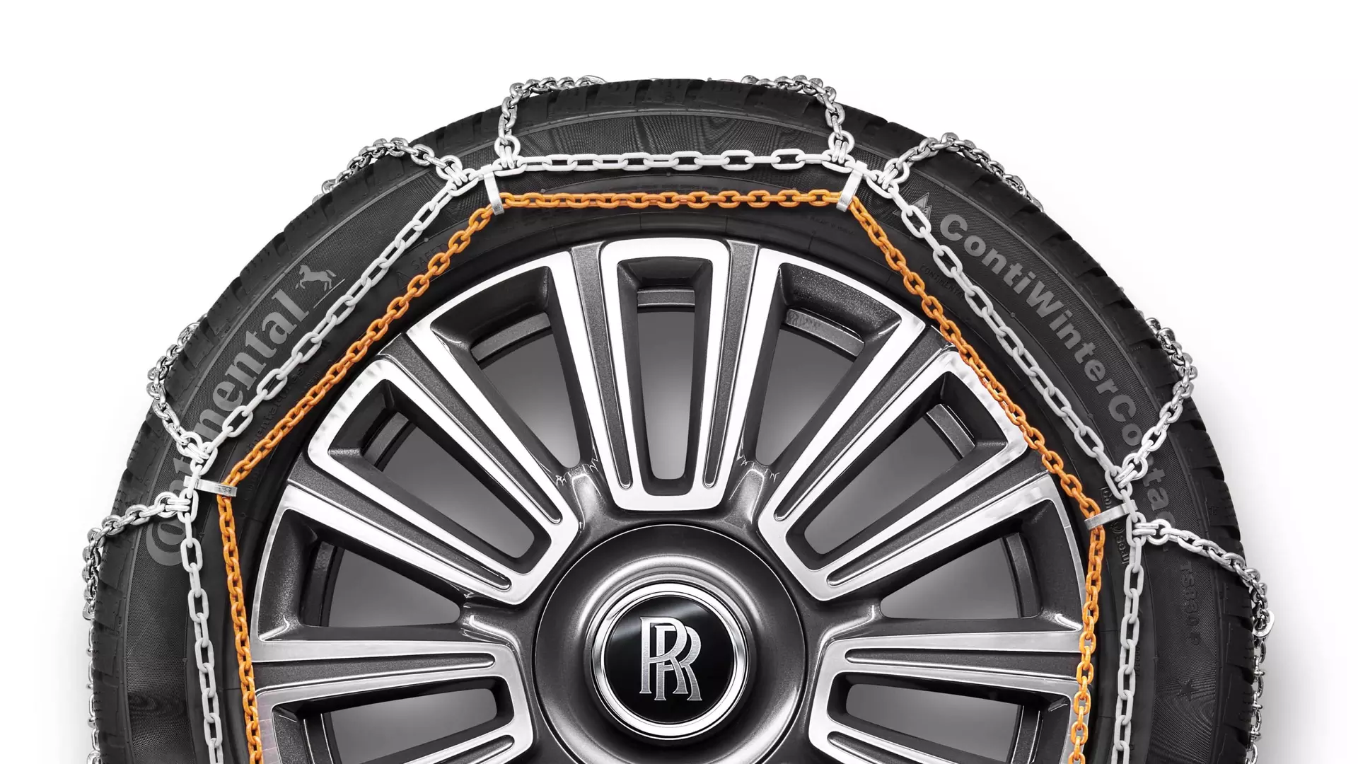 Snow chains on Rolls-Royce motor car with signature monogram on wheel