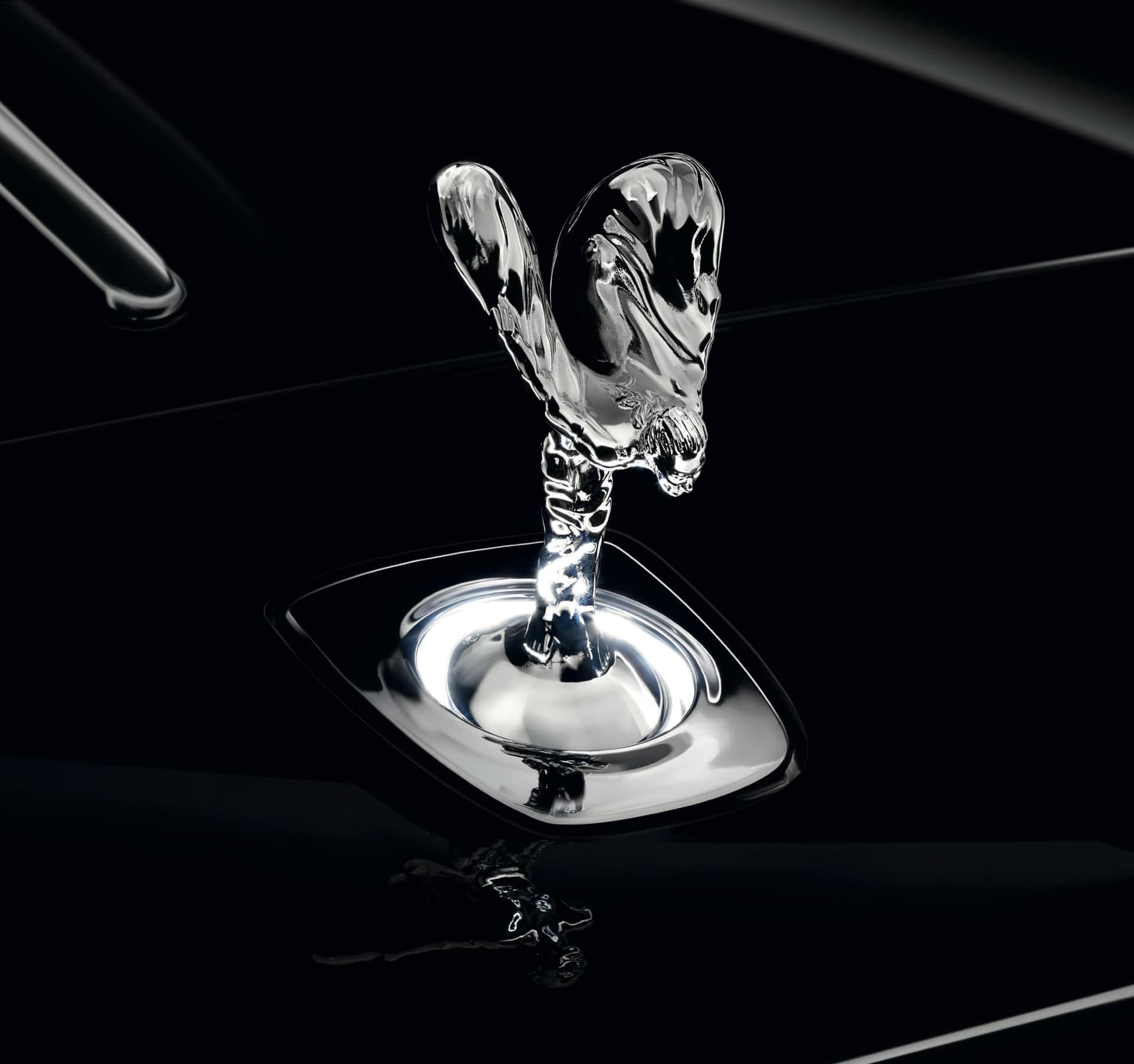 The enchanting Uplit Spirit of Ecstasy with white light halo emanating from the base of the icon