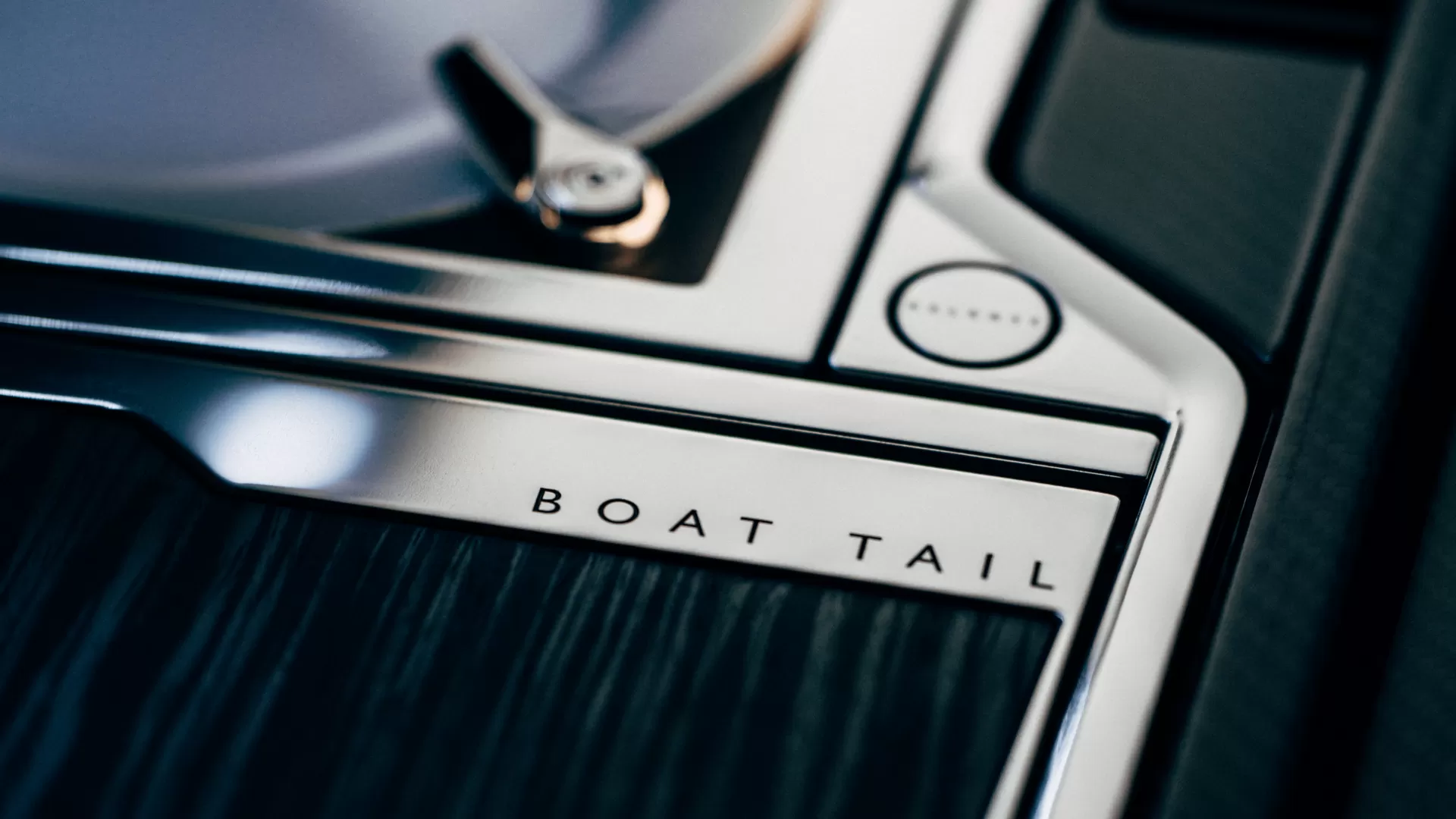 close up of "Boat Tail" etched into the metal feature of the car